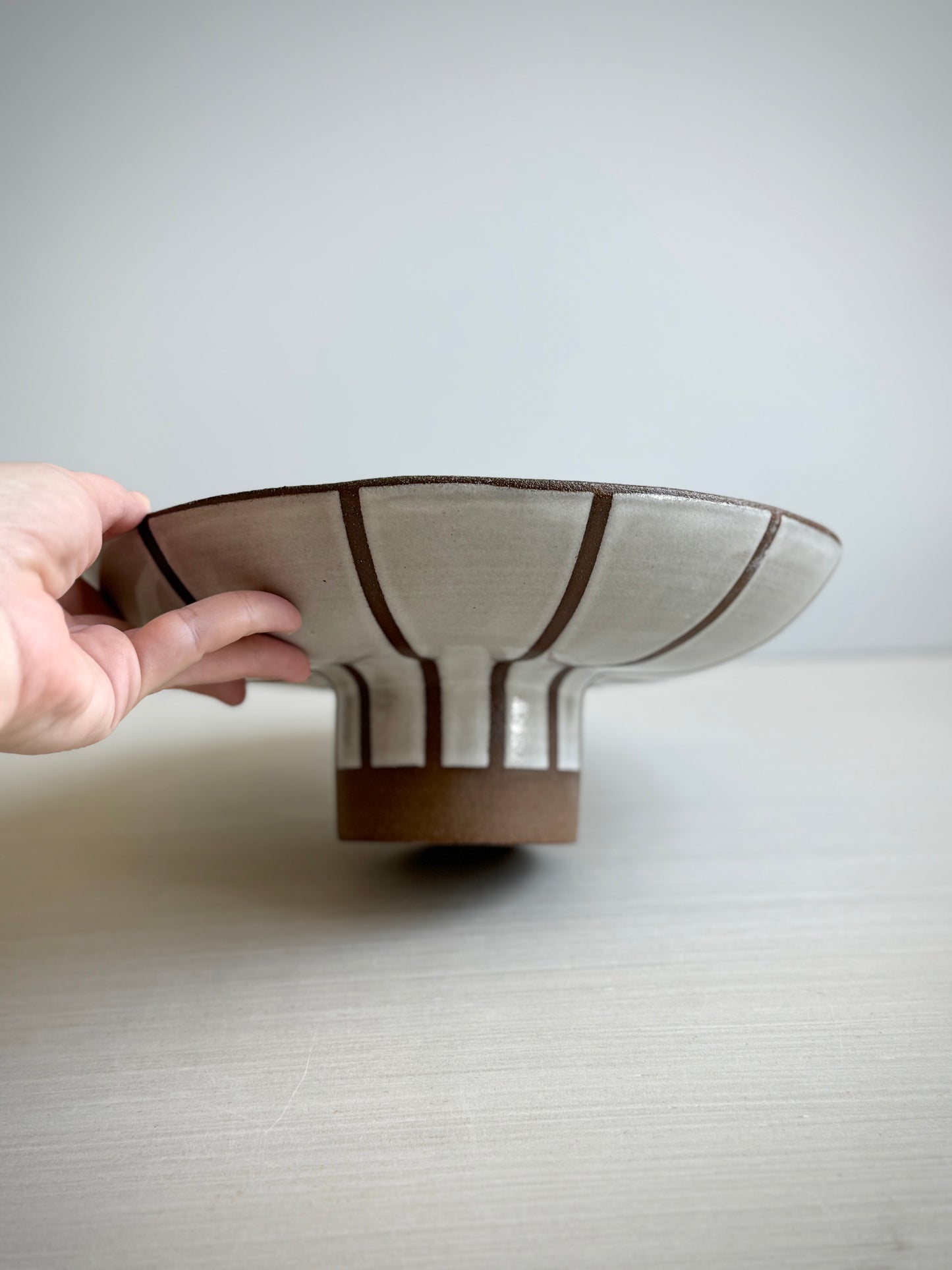 Striped pedestal serving bowl