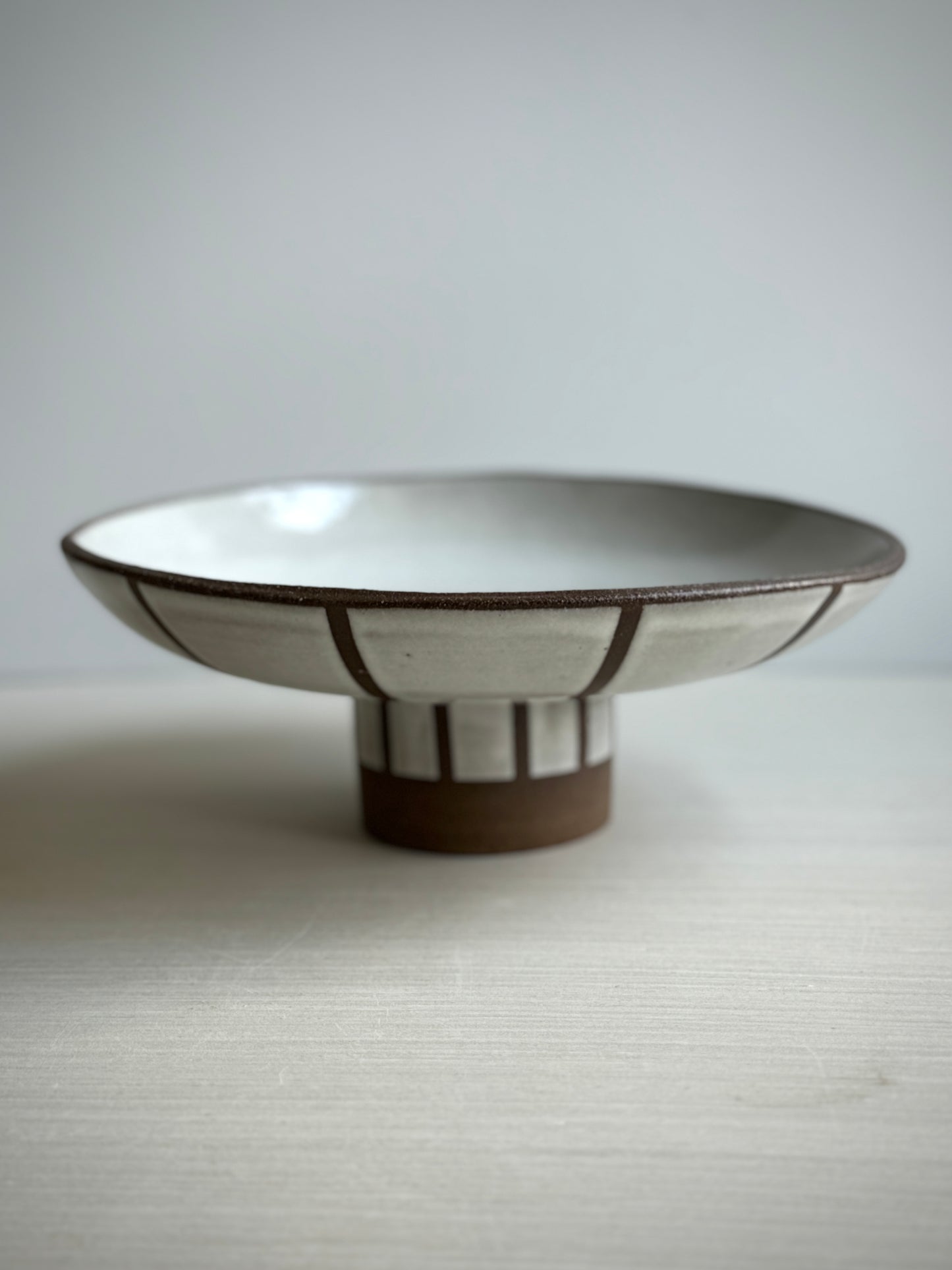 Striped pedestal serving bowl